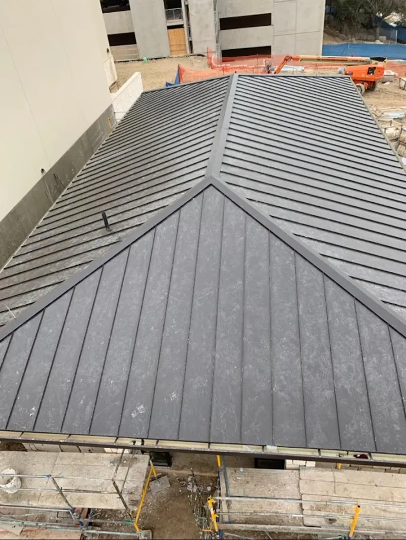 Commercial metal roof construction with crane equipment in Silver City