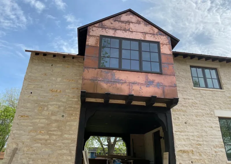 Copper metal panel facade on a stone building for Metal Roof Coating in Silver City