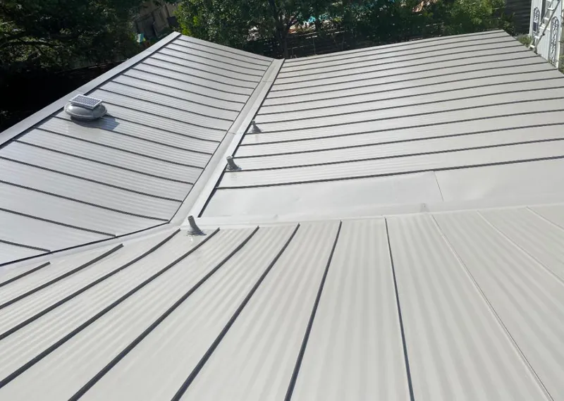 Solar attic fan installed on a metal roof for Roof Ventilation in Silver City